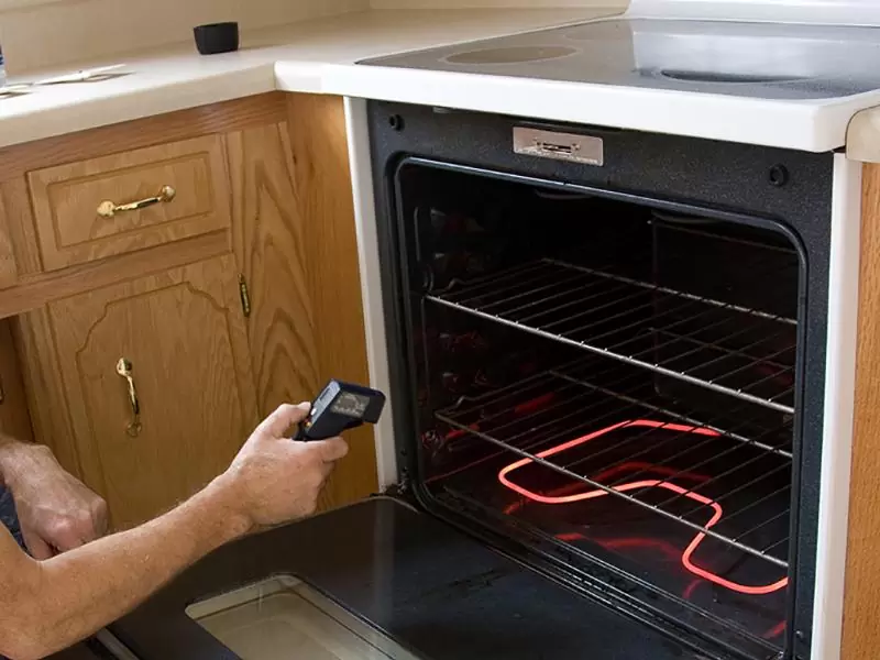 Technician Testing Stove & Oven